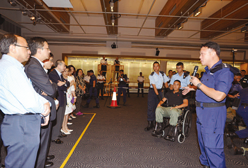 PTU Headquarters officers demonstrate to members of IPCC the tactics used for handling public order events.