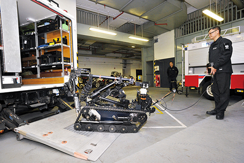 An Explosive Ordnance Disposal Bureau officer demonstrates the Improvised Explosive Device Disposal Robot WHEELBARROW.